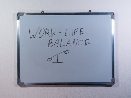 Whiteboard showing WORK-LIFE BALANCE concept with scale drawing representing balance, wellbeing and healthy lifestyleの写真素材