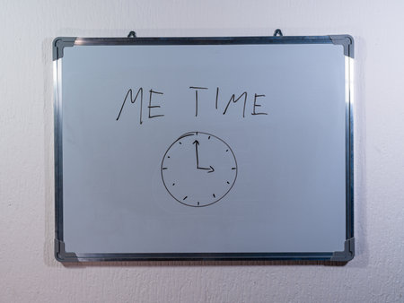 Whiteboard with handwritten text on clean white wall background representing time management and productivity conceptの写真素材