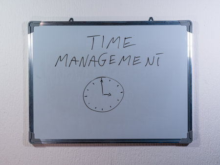 Whiteboard showing TIME MANAGEMENT concept with clock drawing representing productivity, planning and efficient time useの写真素材