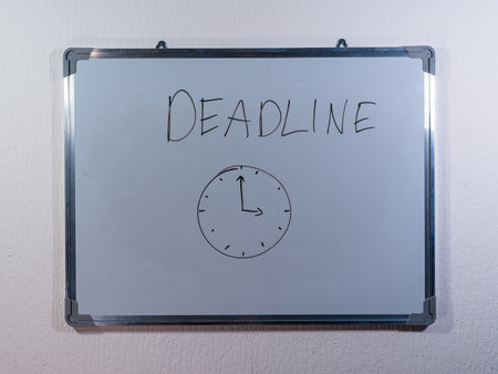 Whiteboard with handwritten text on clean white wall background representing time management and productivity conceptの写真素材