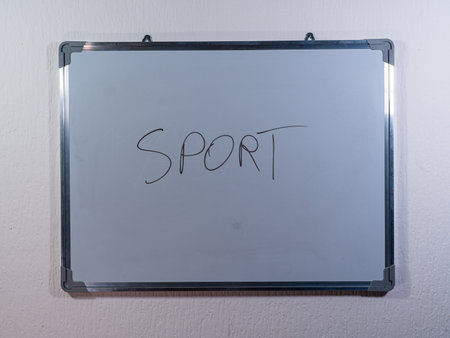 Whiteboard showing SPORT concept on clean white wall background representing physical activity, competition and healthy lifestyleの写真素材