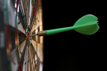 Green dart hitting the target.の写真素材