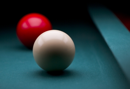 White and red carom balls with dark backgroundの写真素材