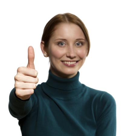 Close-up of a young woman showing thumbs up (focus on finger)の写真素材