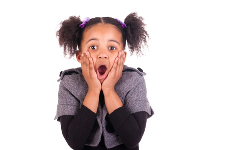 young African girl sticking tongue out, isolated on white backgroundの写真素材