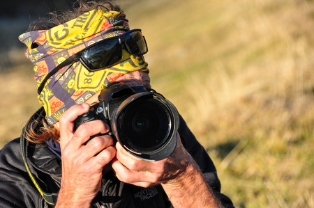 a young photographer makes his photoのeditorial素材