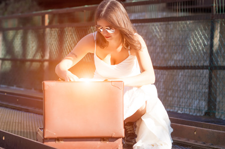 bride looks for something inside her suitcaseの写真素材