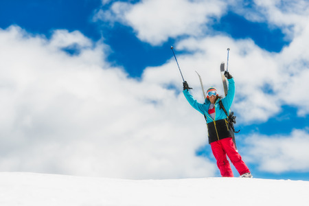 Girl freeride skier, raises his hands before the descent from the topの写真素材