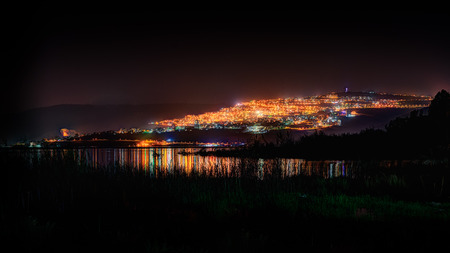 Tiberias at night from the Sea of Galileeの写真素材