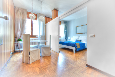 Bed and breakfast dinner table divided by badroomの写真素材