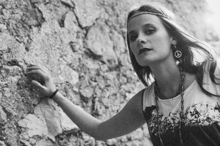 Girl with earring hippie peace symbol, make love not war. photography vintage style.の写真素材