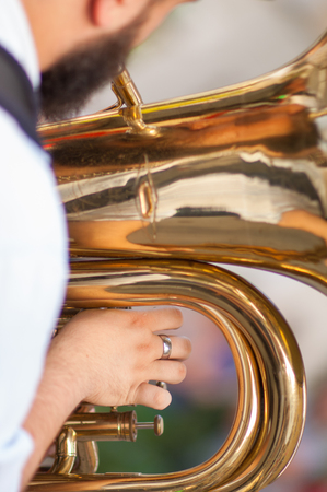 man plays his tuba during an outdoor partyの写真素材