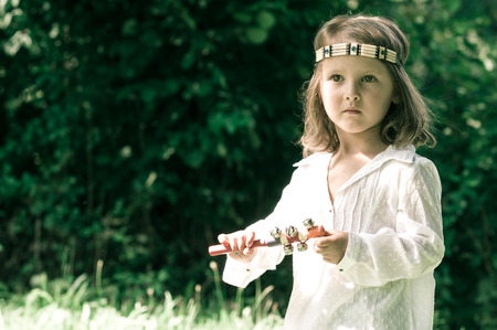 portrait of hippy child playing rattle  in vintage style in vintage styleの写真素材