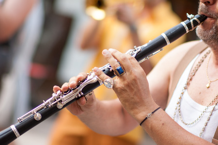 a man makes his performance with his clarinet during a partyの写真素材
