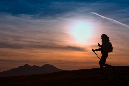 Woman Hiking in the Mountains at Sunset  Outdoor Adventure  Active Lifestyleの写真素材