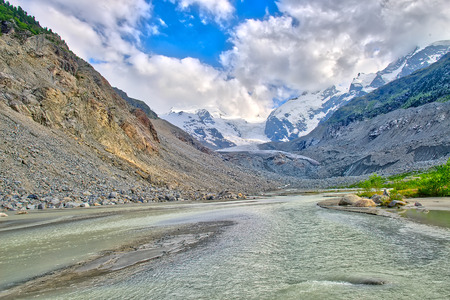 The river starts from the glacier of the Swiss alpsの写真素材