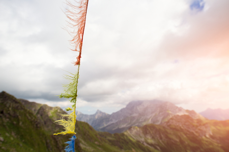 Tibetan prayer flags in the mountains ruined by windの写真素材