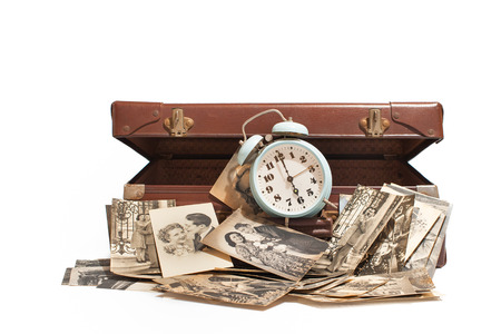Vintage  open suitcase with  bell and old photosの写真素材