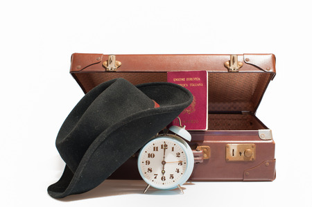 Vintage  suitcase with  italian passport, cap and old  bellの写真素材