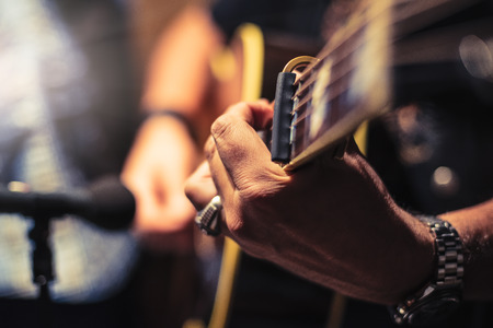Acoustic guitarist in recording studio. Vintage photographyの写真素材