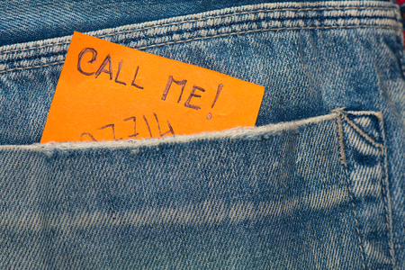 Leaf detail in jeans pocket wrote to call and the numberの写真素材
