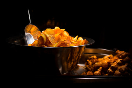 fried potatoes in metal box with black background