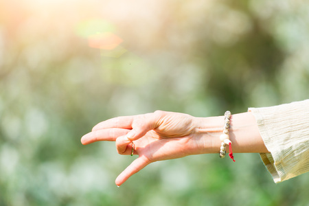 Hand in yoga position in nature of springの写真素材