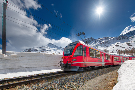 Swiss mountain train Bernina Express crossed Alps with snow wall.のeditorial素材