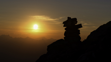 Stacked stones marking the right path of a mountain path.の写真素材