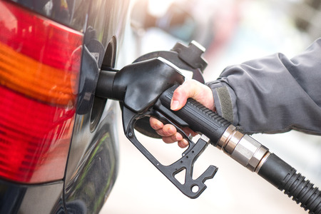 Gasoline pump during supply to a car.の写真素材