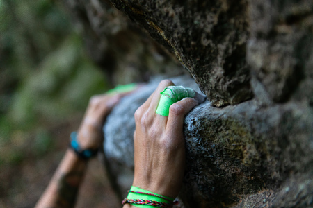 Detail of climber's hands on the rock with bandの写真素材
