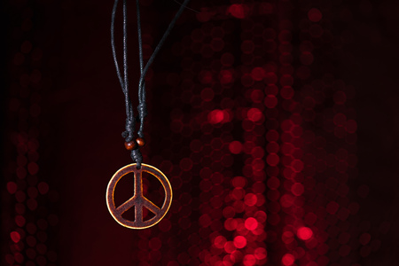 Wooden peace symbol with red lights background.の写真素材
