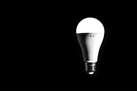 LED light bulb lit on a black background.の写真素材