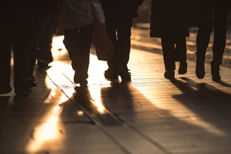 Detail of people walking on the sidewalks of a city.の写真素材