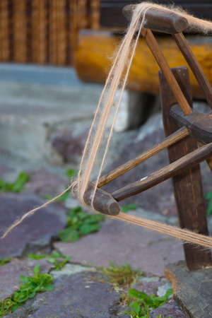 Old woolen spinner tool at work outdoors.の写真素材