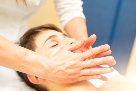 In the aesthetic studio a relaxing facial massage is performed.の写真素材
