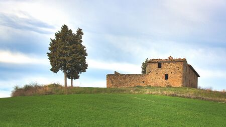 Hermitage crumbling in the meadow in Tuscany Italyの写真素材