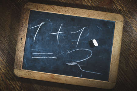 Small blackboard with child simple math calculationの写真素材