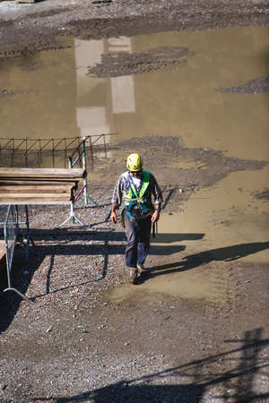 San Pellegrino terme, Italy, 09.08.2020: Worker walks on a construction siteのeditorial素材