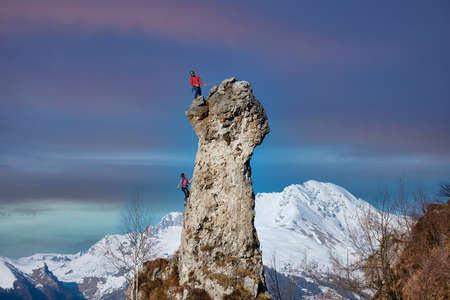 Rocky peak with a couple of climbers in ropesの写真素材