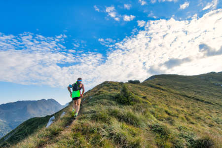 Sporty mountain man rides in trail during endurance raceの写真素材