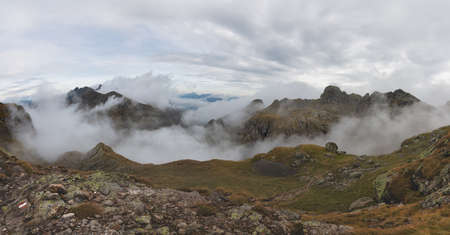 Alpine panorama with clouds in the valleysの写真素材