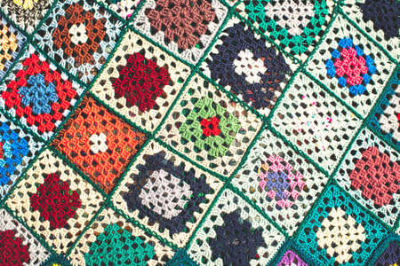 Detail of crocheted wool blanket with colorful checksの写真素材