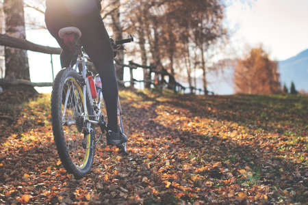 Passage of a mountain bike on leafy paths in the hills in autumnの写真素材