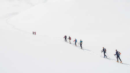 Ski mountaineering ascent track in swiss alps with people climbingの写真素材