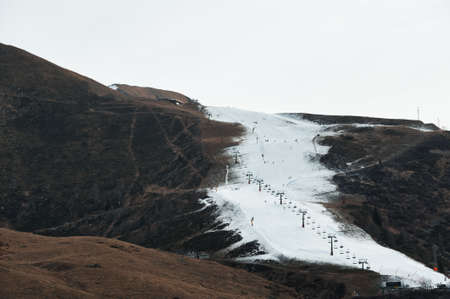 Ski slope with only artificial snow in a dry winterの写真素材