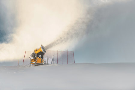 A snow cannon in action at a ski resortの写真素材