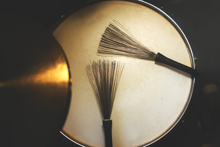 Drum sticks brushes on snare drum