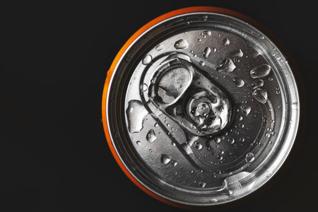 Aluminum can of beverage covered with water drops on black backgroundの写真素材