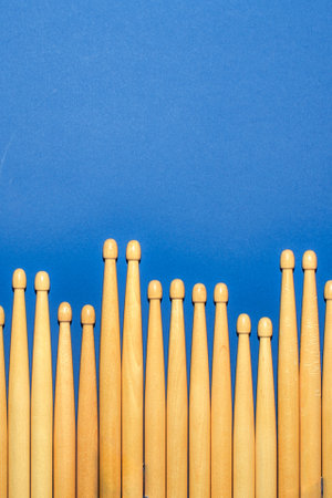 Paired drumsticks on a blue backgroundの写真素材